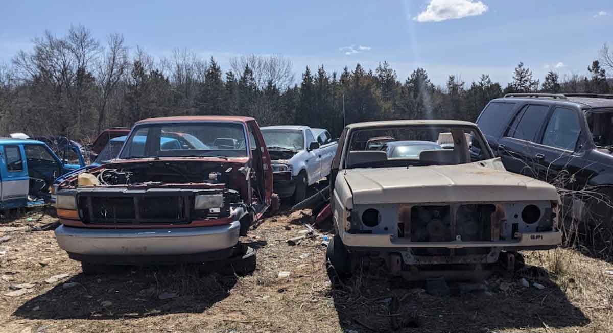 Junked vehicles at Fenton Auto Salvage yard at 6650 Treasure Dr, House Springs, MO 63051