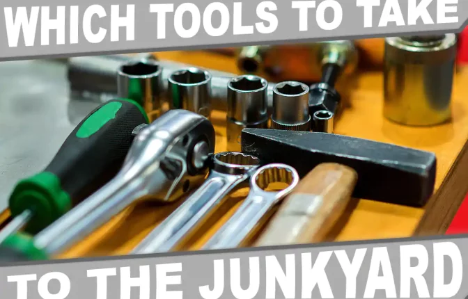 An assortment of hand tools commonly used for part removal in a junkyard