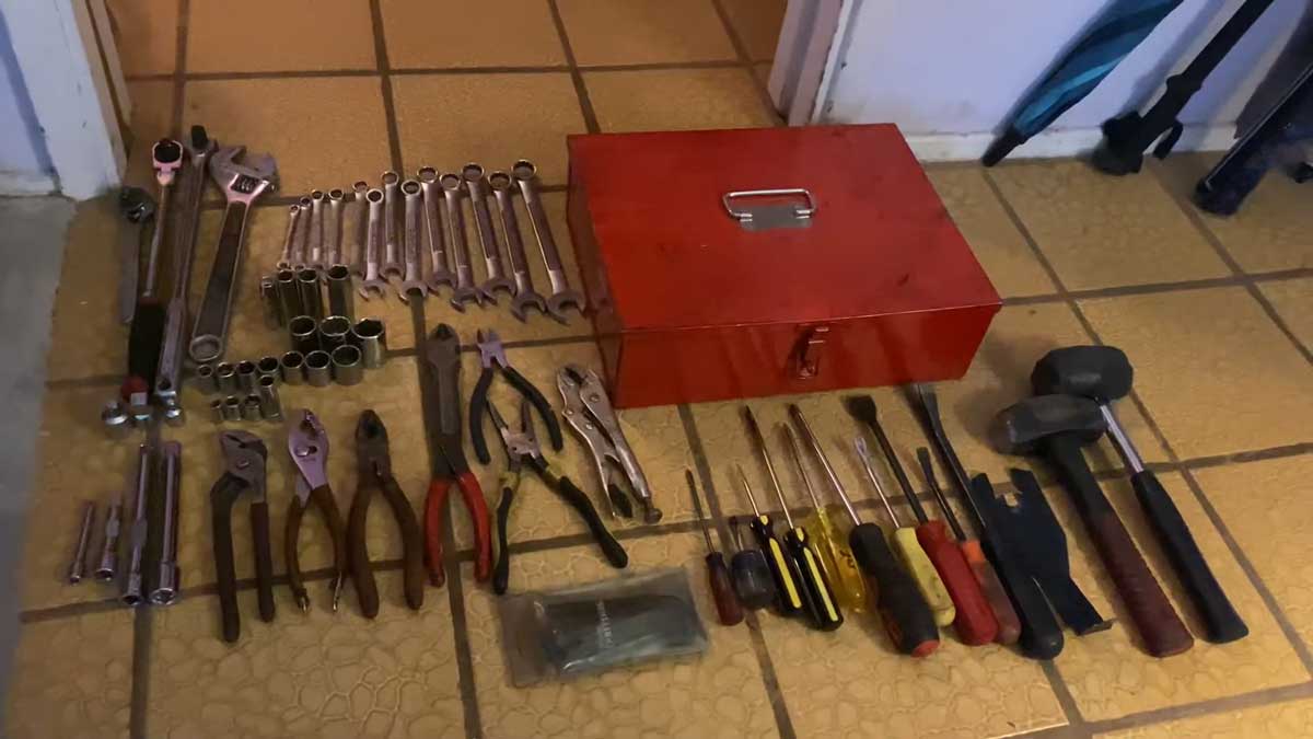 A set of tools laid out for removing a car radiator